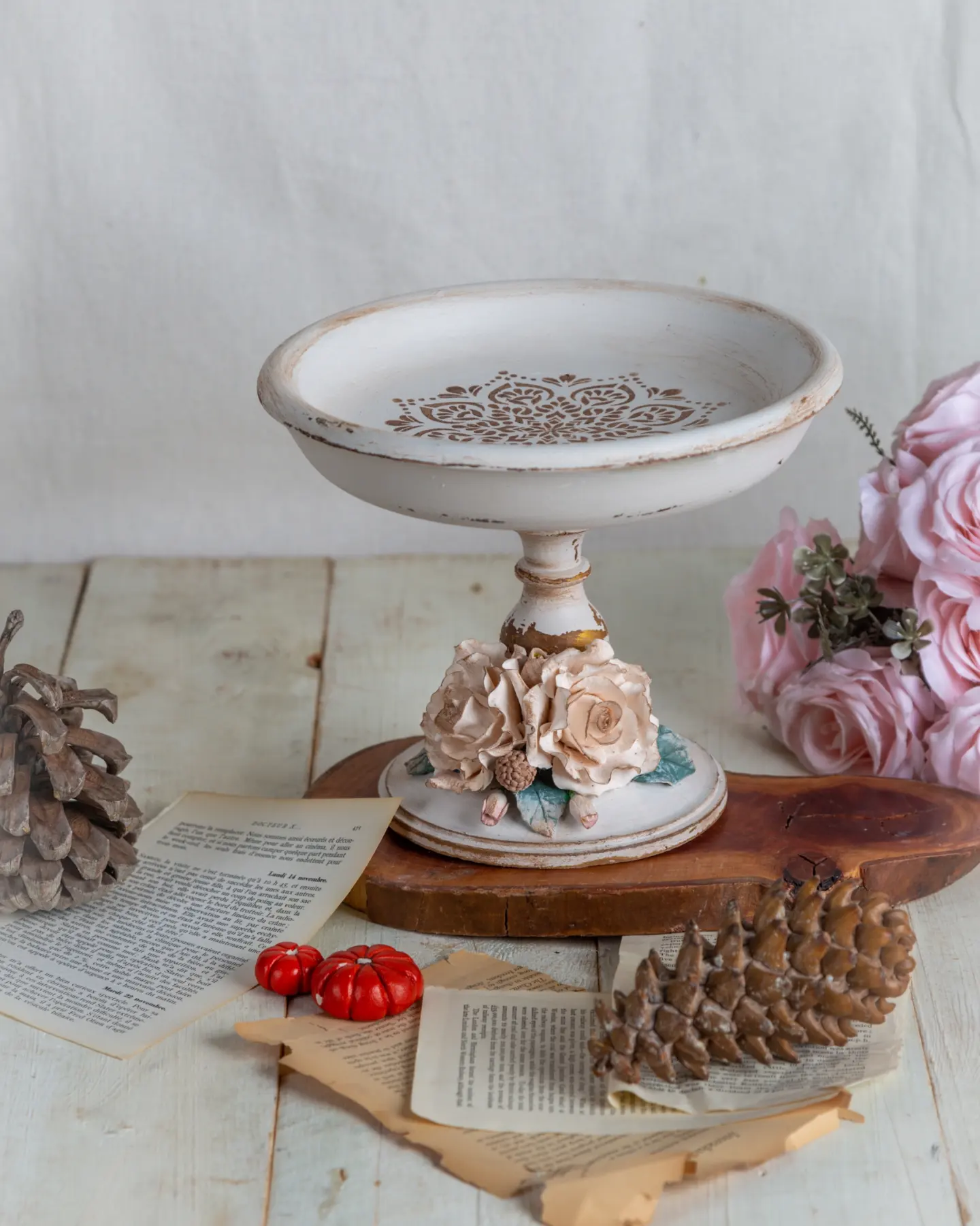 White stenciled pedestal dish with ceramic roses